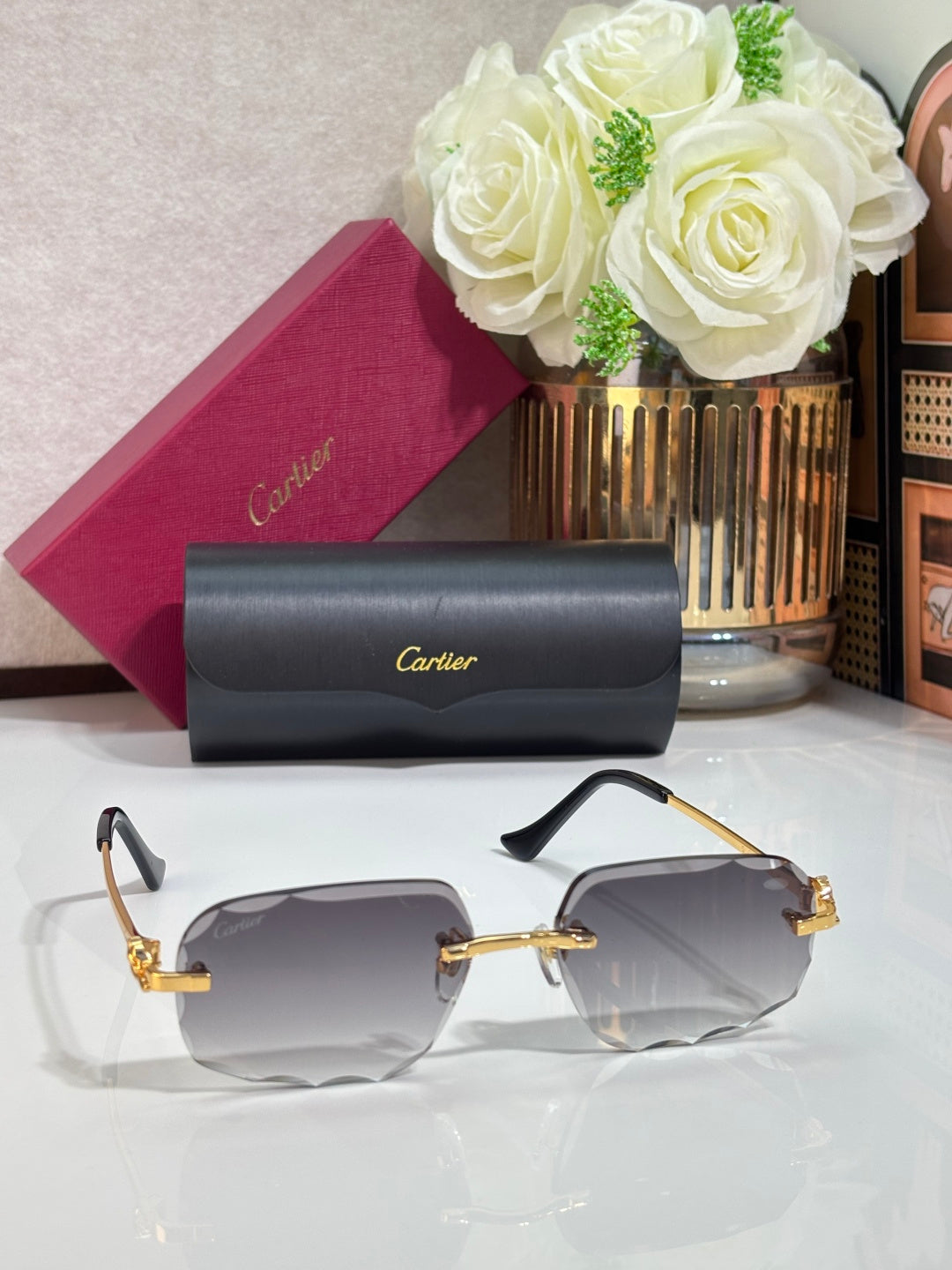 Gold-tone Cartier eyeglasses with blue-tinted lenses, black temples, and folded case
