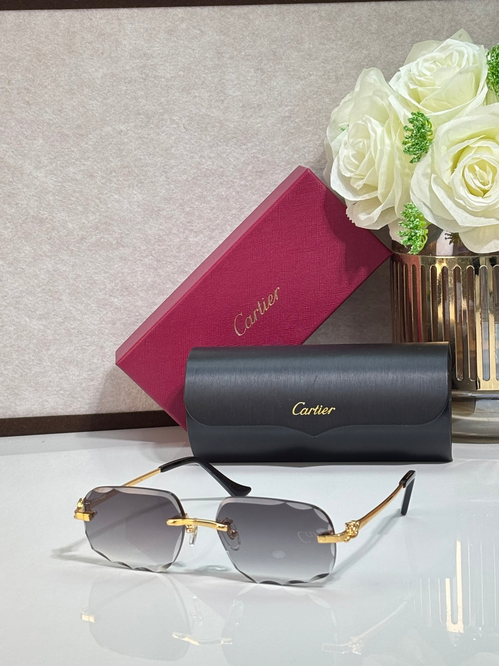Rectangular gold-tone Cartier eyeglass frame with gray gradient lenses and black temples