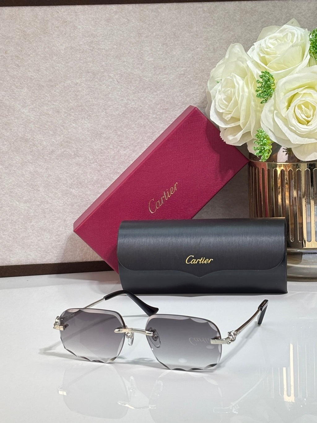 Rectangular gold-tone Cartier eyeglass frame with gray gradient lenses and black temples