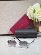 Rectangular gold-tone Cartier eyeglass frame with gray gradient lenses and black temples