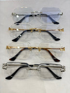 Set of Cartier eyeglass frames with clear and blue-tinted lenses and metal temple arms