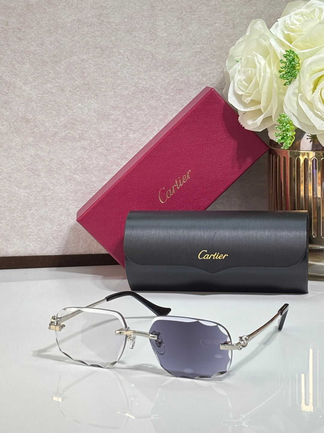 Cartier eyeglasses with silver-tone rectangular frames and blue-tinted lenses, dark temple tips