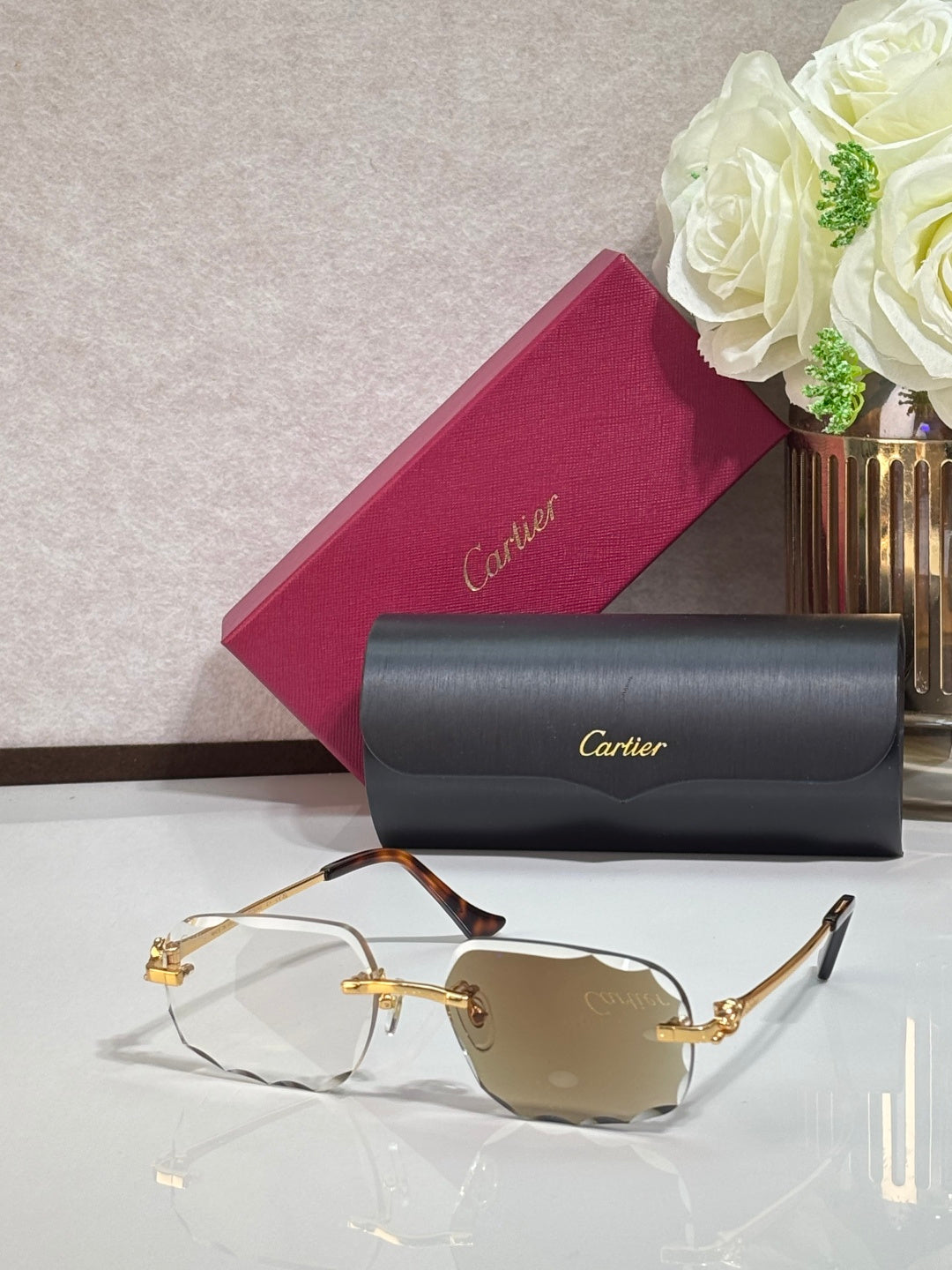 Cartier eyeglasses with gold rectangular frames and amber-tinted lenses, dark temple tips