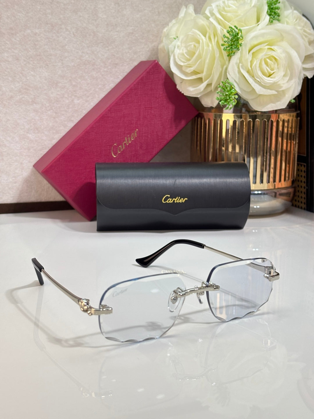 Cartier eyeglasses with gold-tone full-rim frames and clear lenses, black temple tips