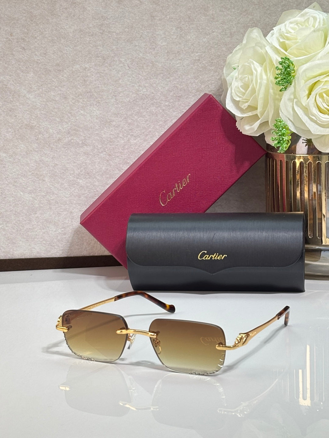 Cartier glasses with gold metal frames and brown tinted rectangular lenses