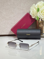Cartier eyeglasses with gold temples and clear rectangular lenses