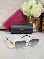 Cartier glasses with gold metal temples and dark blue tinted rectangular lenses