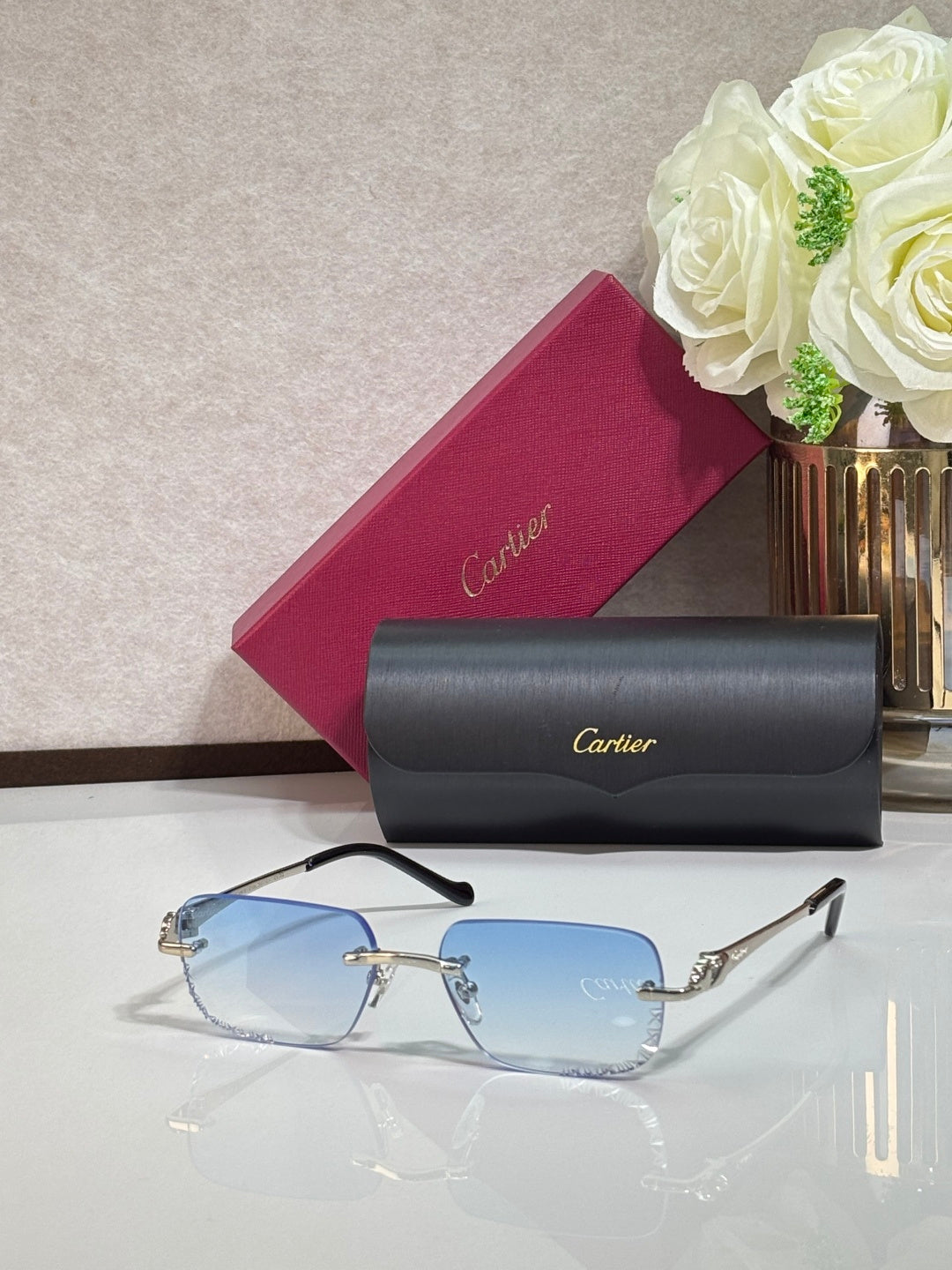 Cartier glasses with gold metal temples and blue-tinted rectangular lenses