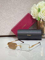 Cartier glasses with gold metal frames and amber tinted rectangular lenses