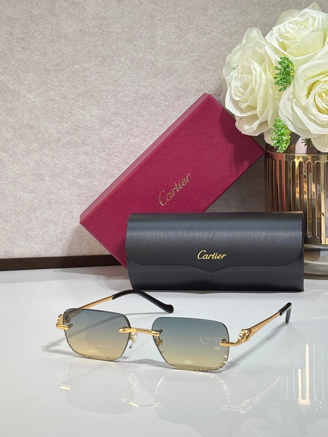 Cartier glasses with gold metal temples and amber tinted rectangular lenses