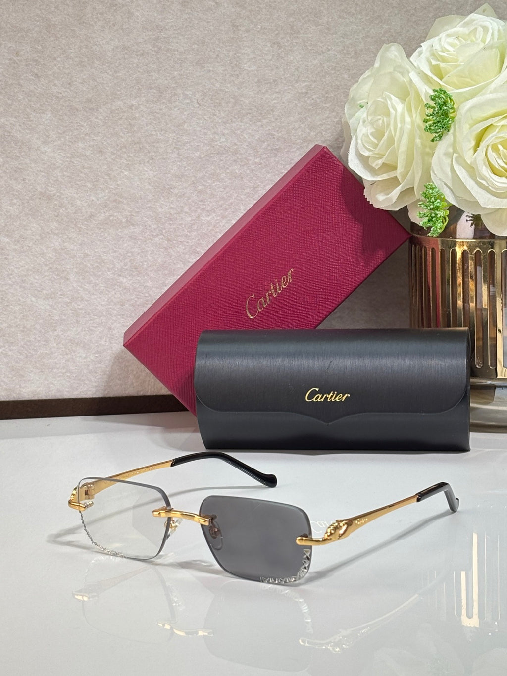 Cartier glasses with gold metal frames and light blue tinted rectangular lenses