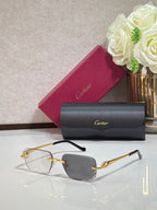 Cartier glasses with gold metal frames and light blue tinted rectangular lenses