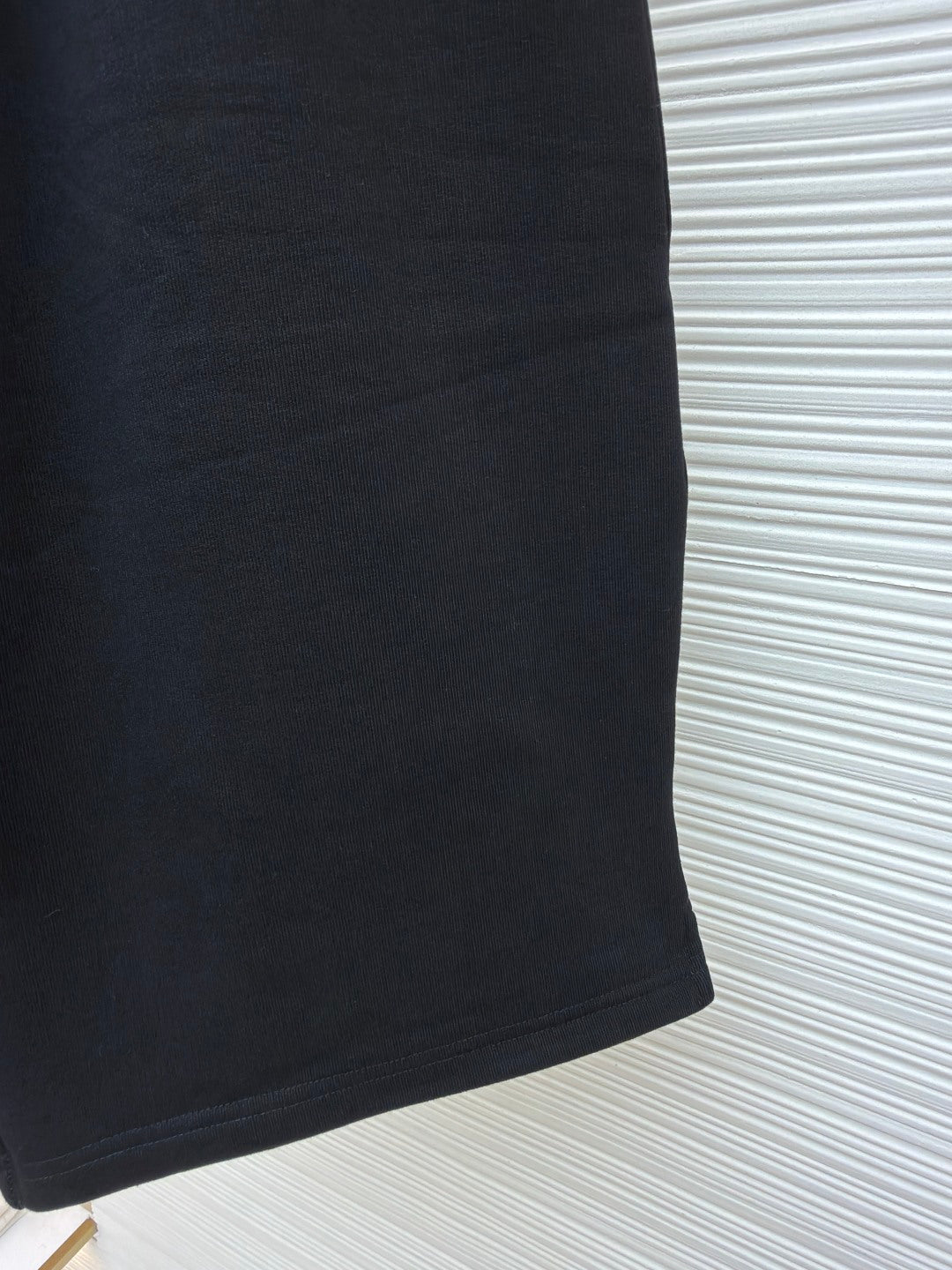 Dark shorts with clean side seam and smooth fabric panel