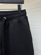Dark drawstring shorts with small embroidered logo on front pocket