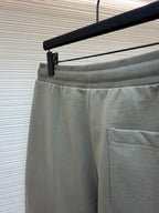 Amiri shorts back view, light gray with side pocket and smooth waistband