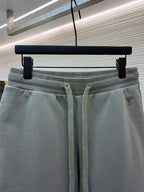 Amiri shorts front view, light gray with drawstring and small logo near hem