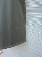 Amiri shorts side view, light gray with clean hem and fabric drape