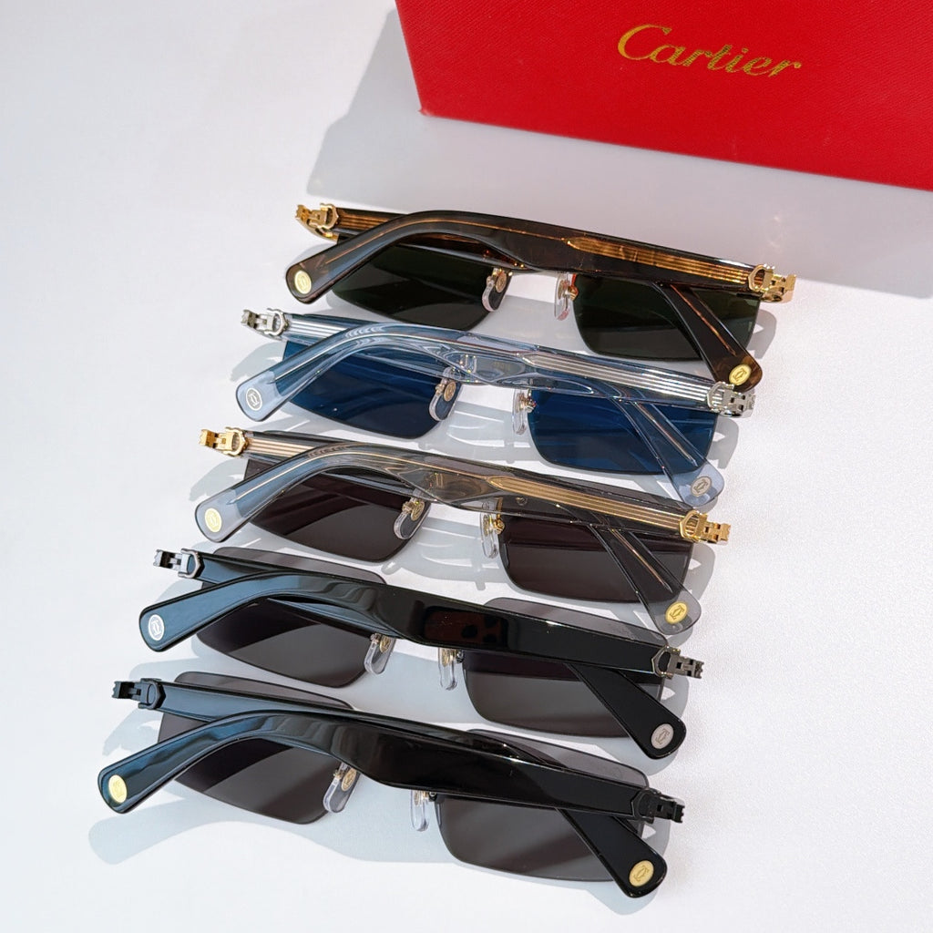 Stack of sunglasses with mixed dark lenses and gold-tone metal frames.