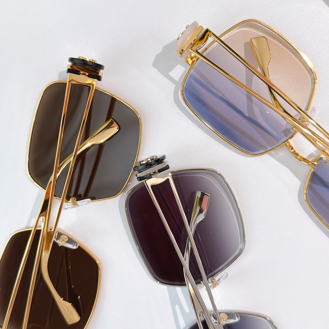 Chanel sunglasses set with gold-tone frames and tinted square lenses, close-up view.