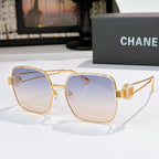 Chanel gold-tone sunglasses with pale blue square lenses and gold bridge hardware.