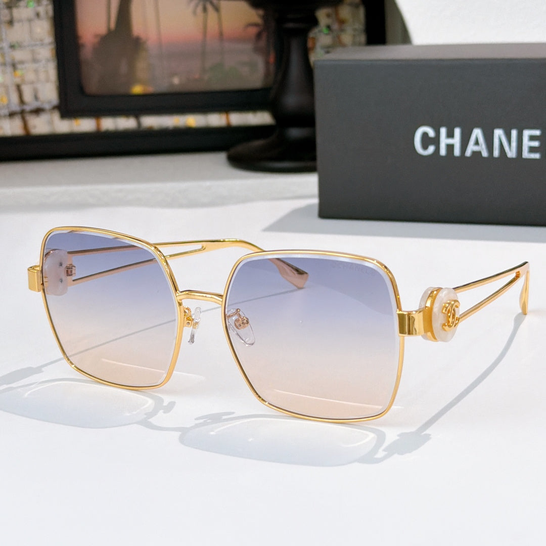 Chanel gold-tone sunglasses with pale blue square lenses and gold bridge hardware.
