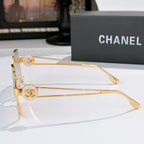Chanel gold-tone sunglasses side profile with round logo emblem and tinted square lenses.