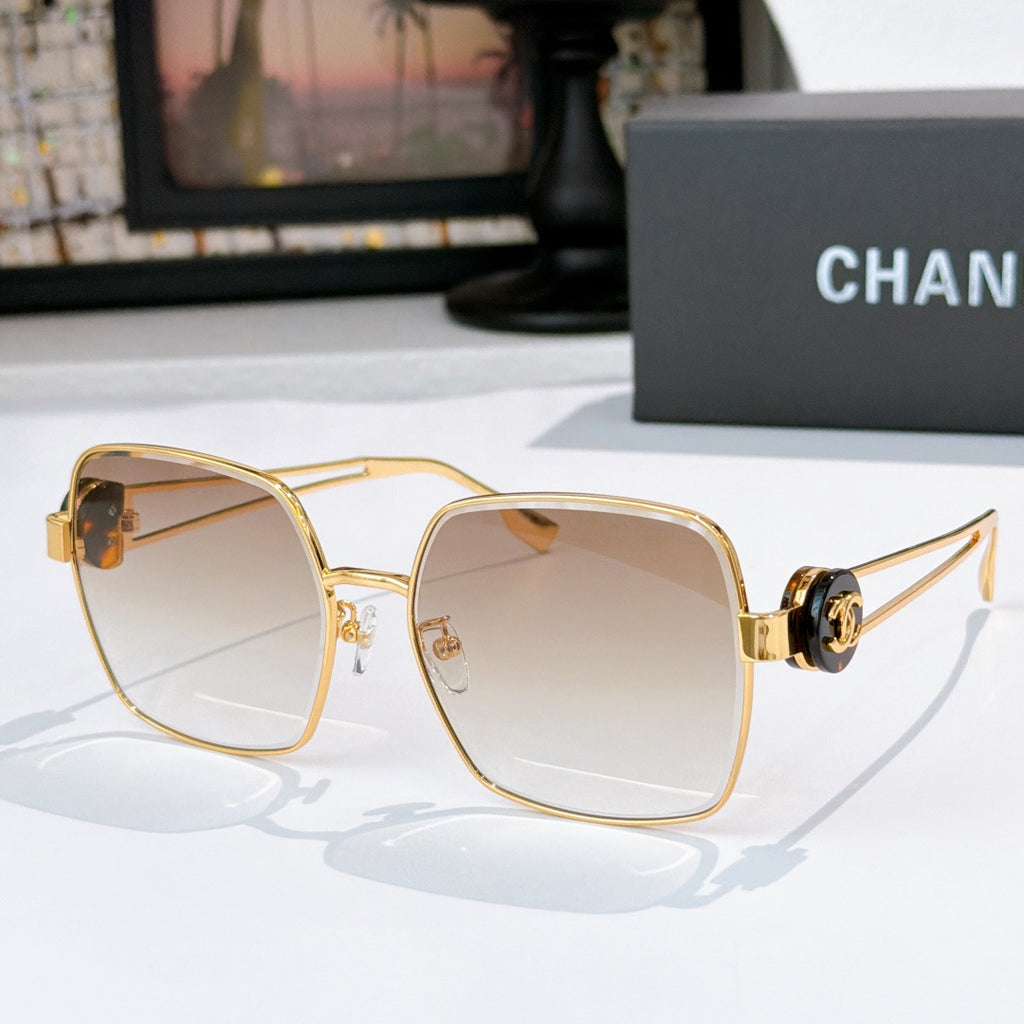 Chanel gold-tone sunglasses with light beige square lenses and logo hinge detail.