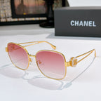 Gold-frame sunglasses with pink tinted lenses and curved cat-eye shape