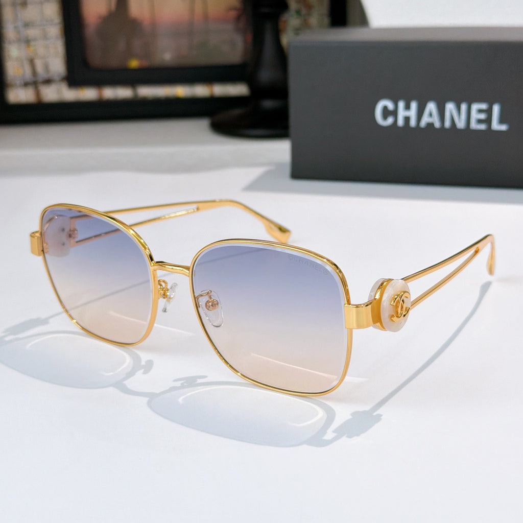 Gold-frame sunglasses with light blue tinted lenses and slim angular temples