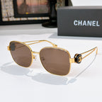 Gold-frame sunglasses with brown tinted lenses and rounded cat-eye silhouette