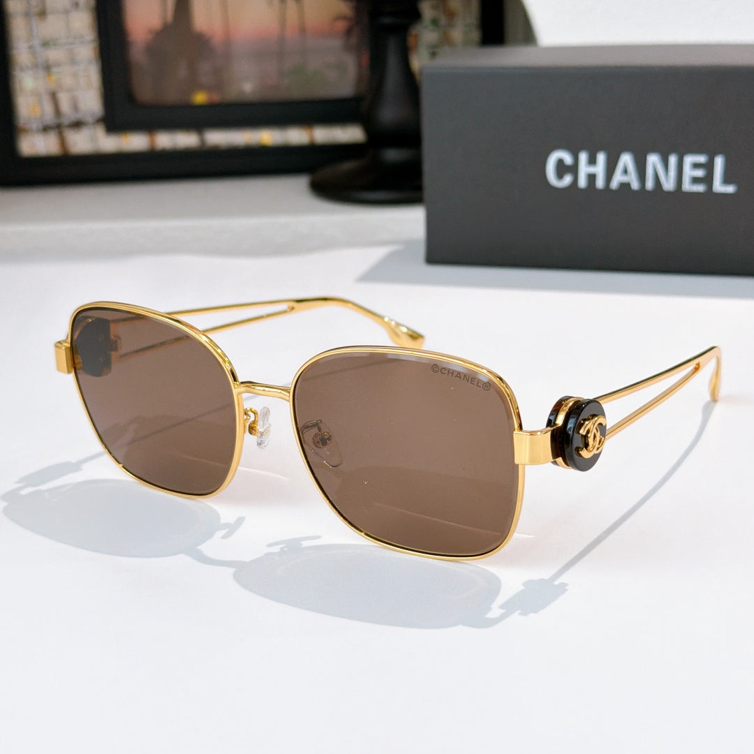 Gold-frame sunglasses with brown tinted lenses and rounded cat-eye silhouette