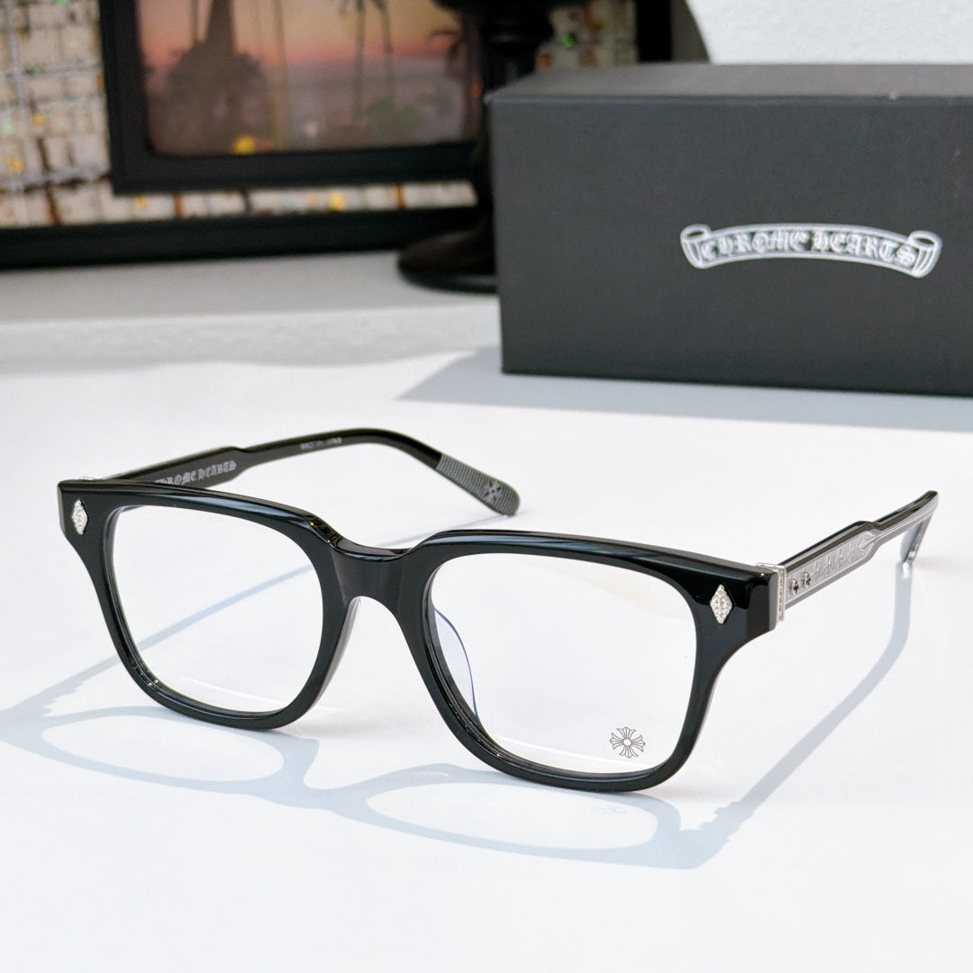 Black eyeglasses with full-rim frames, clear lenses, and small decorative emblem details