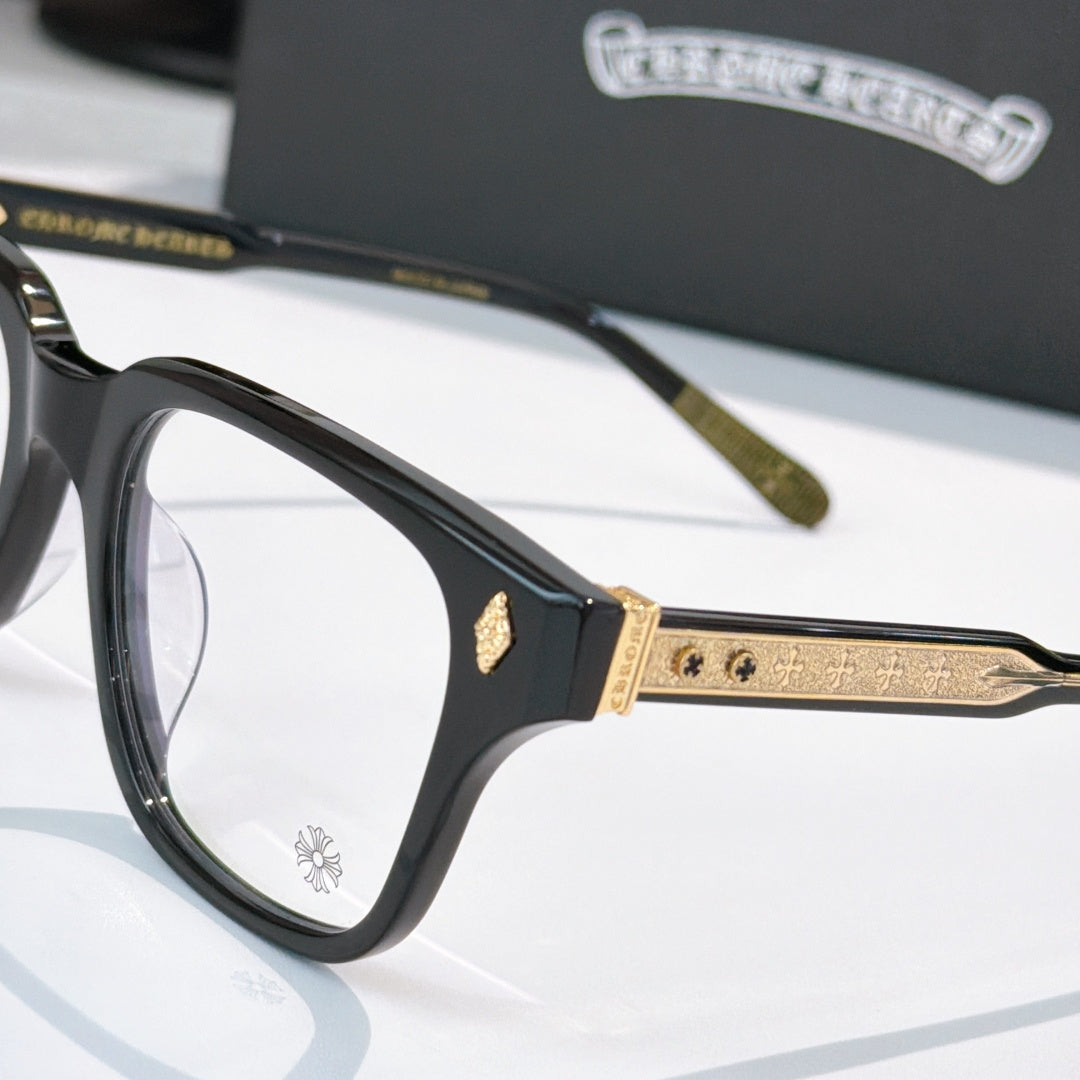 Black full-rim eyeglasses close-up with gold temple details and clear lenses