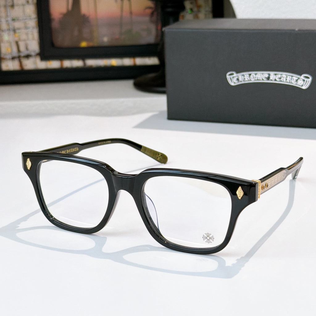 Black eyeglasses with gold-tone temple accents and clear lenses, full-rim style
