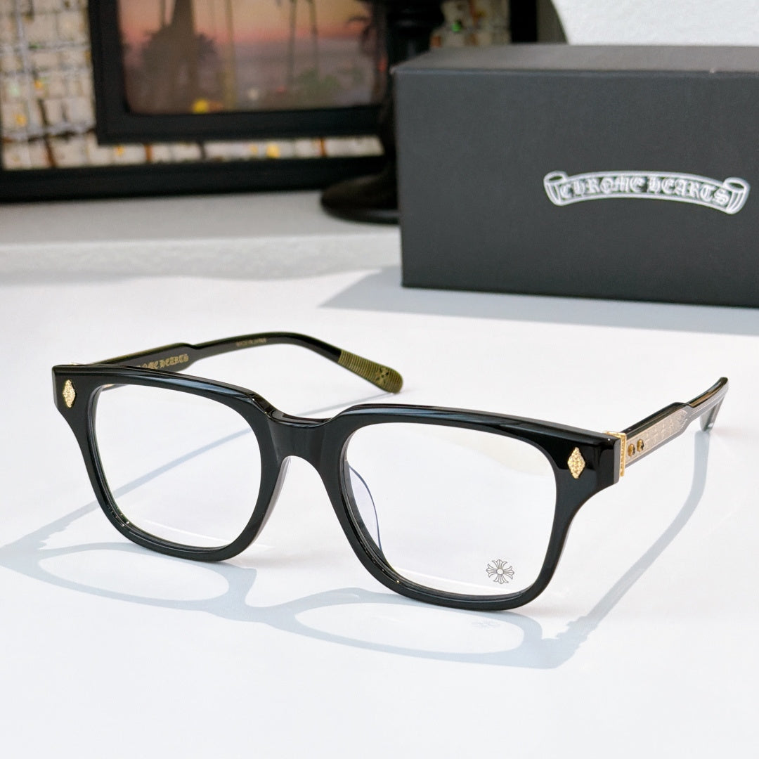 Black eyeglasses with gold-tone temple accents and clear lenses, full-rim style