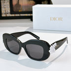 Dior sunglasses with black frames and dark-tinted lenses, with white floral temple detail