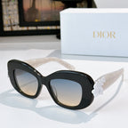 Dior sunglasses with black frames and light-tinted lenses, featuring a white floral temple detail