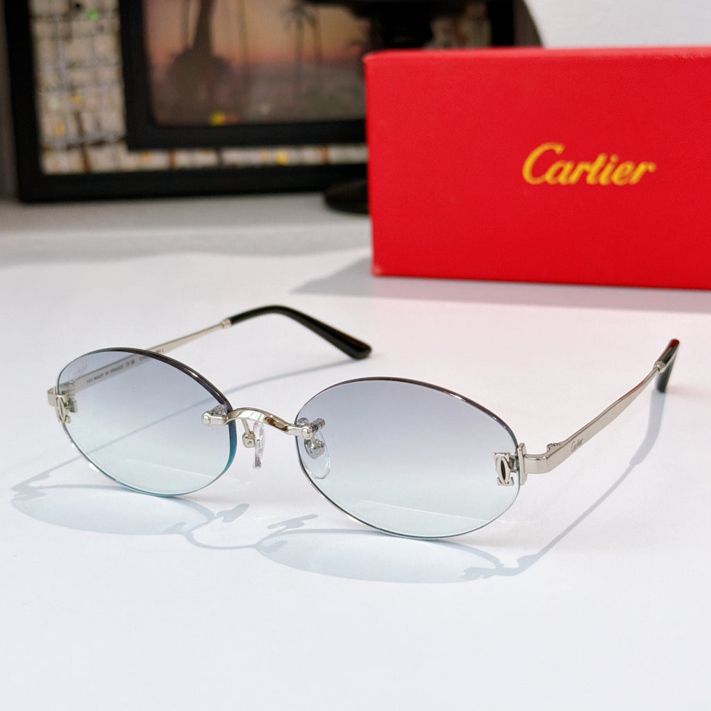 Cartier eyeglasses with clear silver frame and light blue lenses, round-rectangular profile