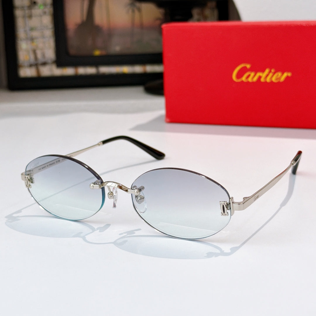 Cartier eyeglasses with clear silver frame and light blue lenses, round-rectangular profile