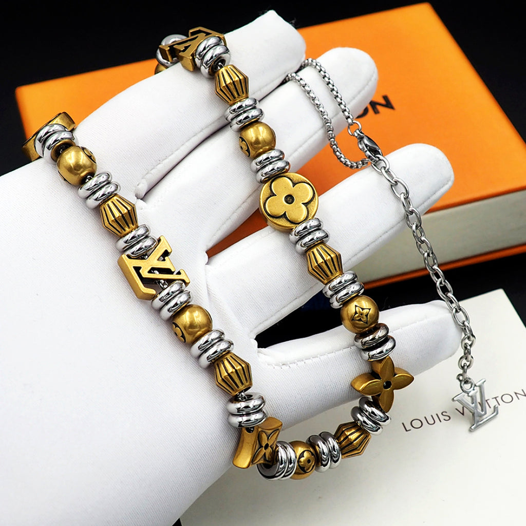 Louis Vuitton beaded necklace and charm bracelet with gold and silver beads on pouch