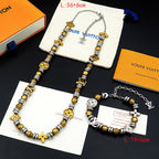 Louis Vuitton beaded necklace with gold and silver charms, paired with matching bracelet