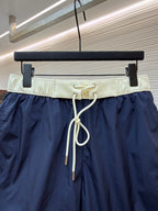 Moncler navy shorts with cream elastic waistband and white drawstring cords