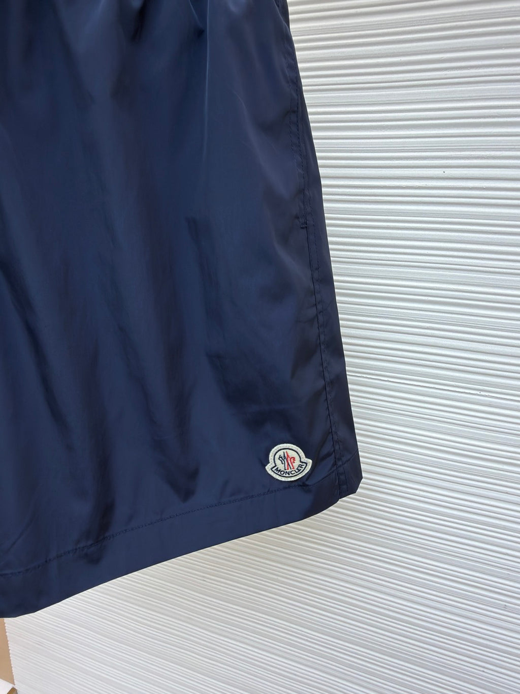 Moncler navy shorts with embroidered logo patch at the hem