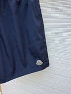 Moncler navy shorts with embroidered logo patch at the hem