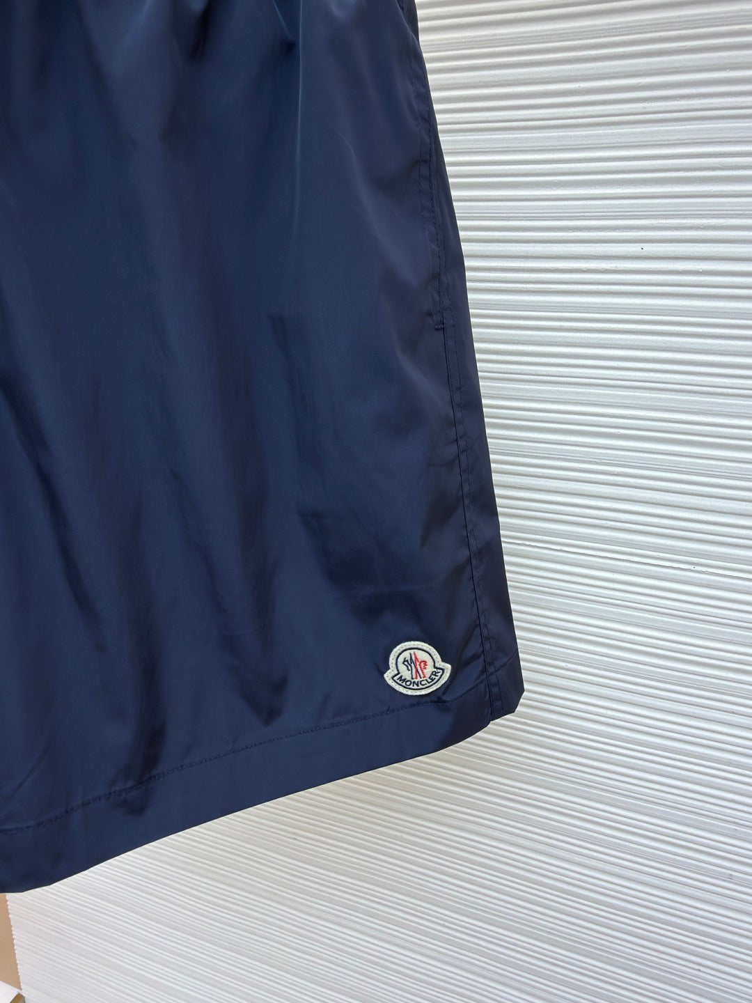 Moncler navy shorts with embroidered logo patch at the hem