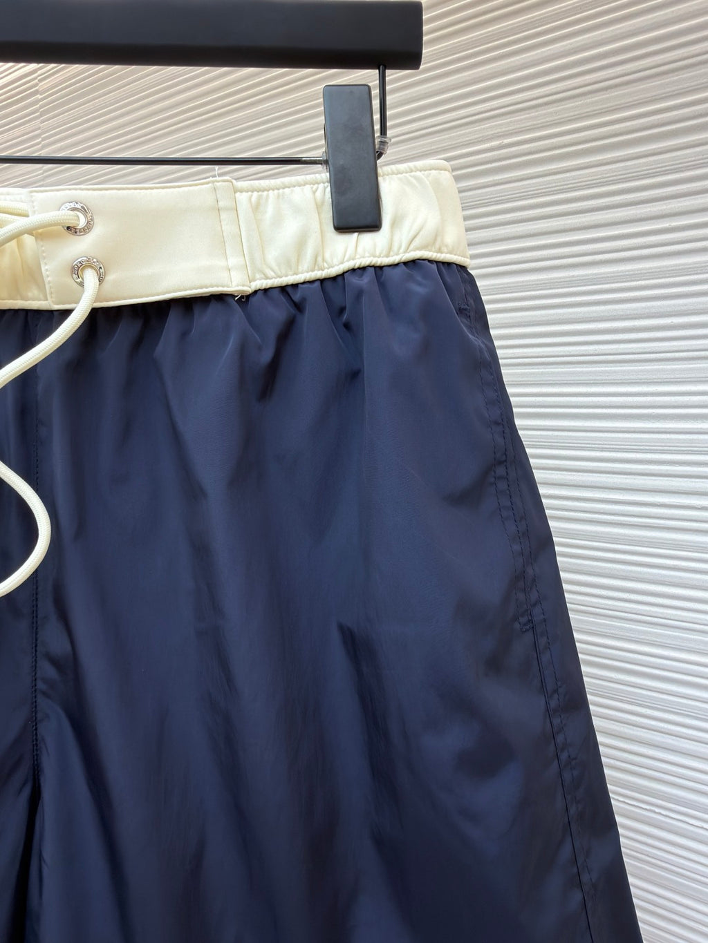 Moncler navy shorts with cream waistband and white drawstring cord with metal tips