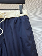Moncler navy shorts with cream waistband and white drawstring cord with metal tips