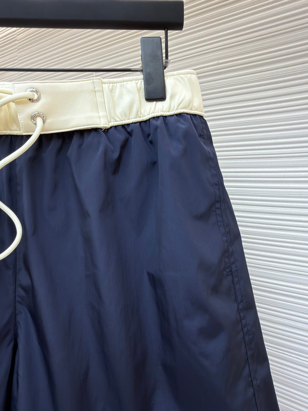 Moncler navy shorts with cream waistband and white drawstring cord with metal tips