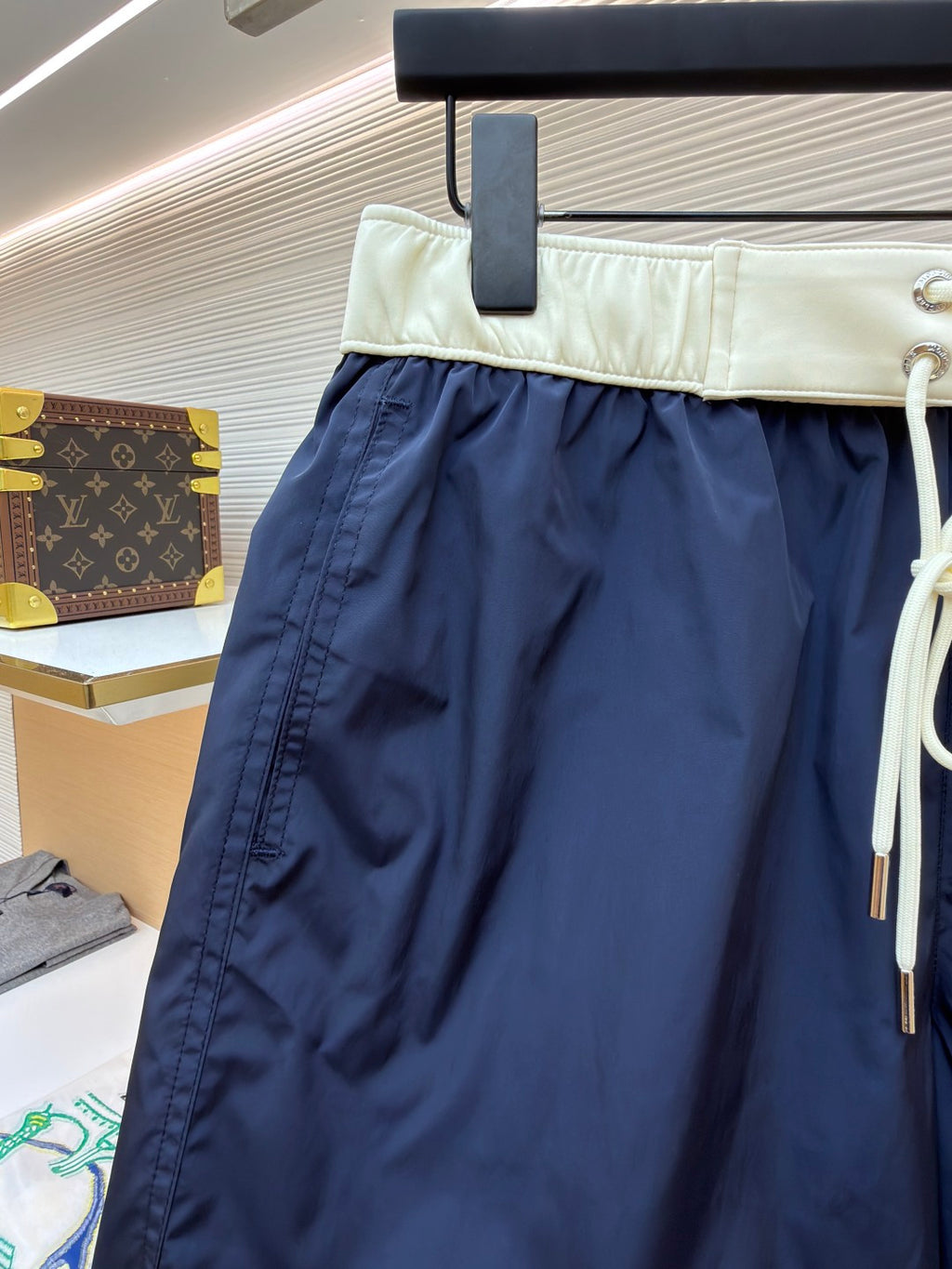 Moncler navy shorts with cream waistband and side seam detail; white drawstring cord