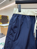 Moncler navy shorts with cream waistband and side seam detail; white drawstring cord